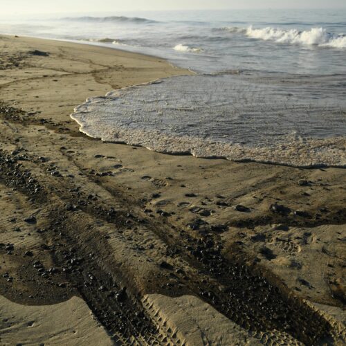 Oil is seen on the beach in Huntington Beach, California on October 3, 2021, after a pipeline breach connected to an oil rig off shore started leaking oil, according to an Orange County Supervisor.