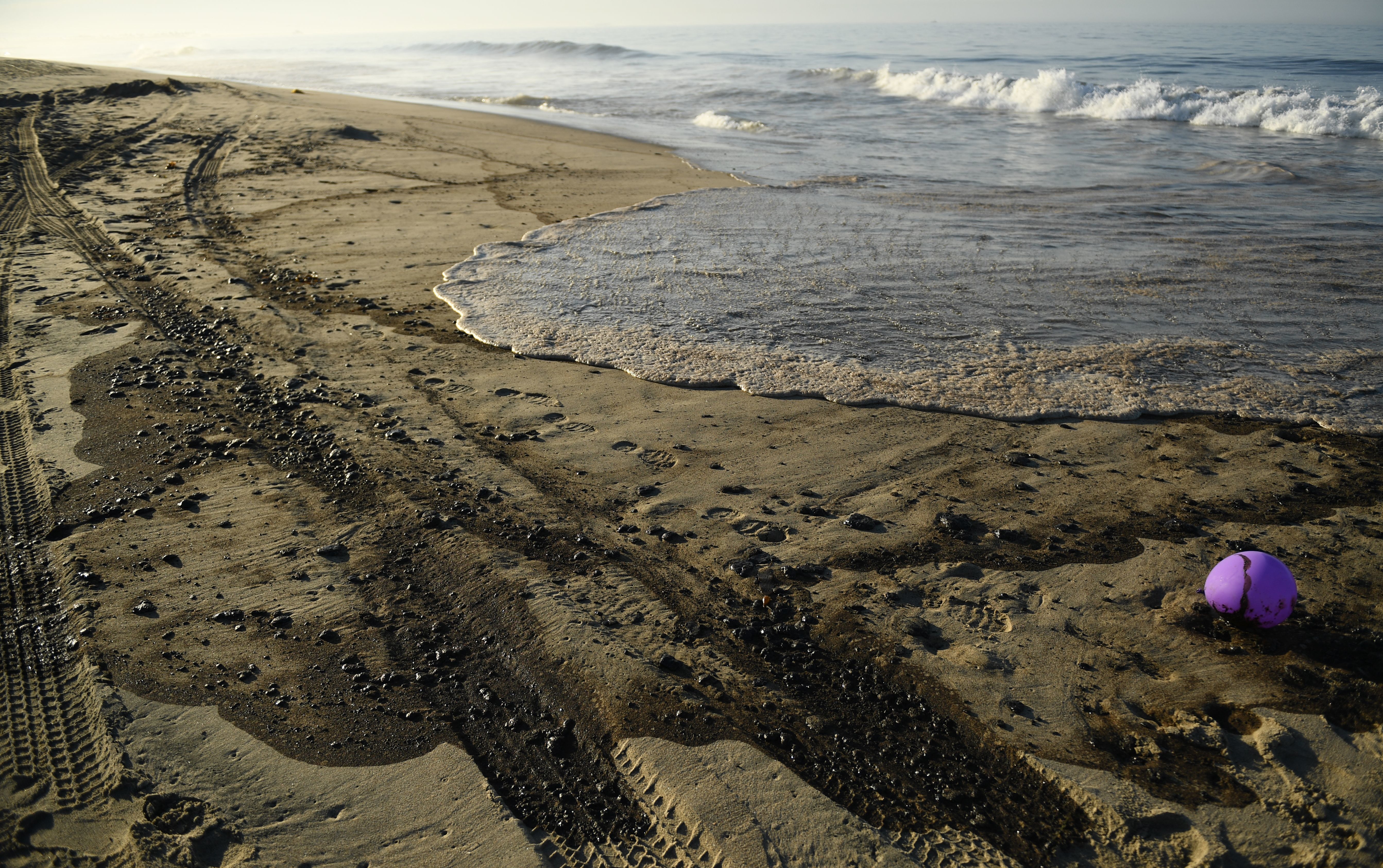Oil is seen on the beach in Huntington Beach, California on October 3, 2021, after a pipeline breach connected to an oil rig off shore started leaking oil, according to an Orange County Supervisor.