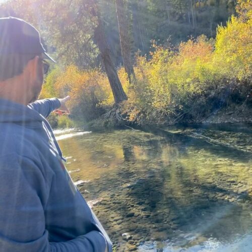 Casey Baldwin, a research scientist with the Confederated Tribes of the Colville Reservation, points out a salmon nest, or redd, on the Sanpoil River.