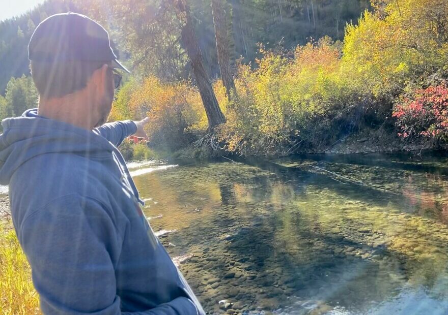 Casey Baldwin, a research scientist with the Confederated Tribes of the Colville Reservation, points out a salmon nest, or redd, on the Sanpoil River.