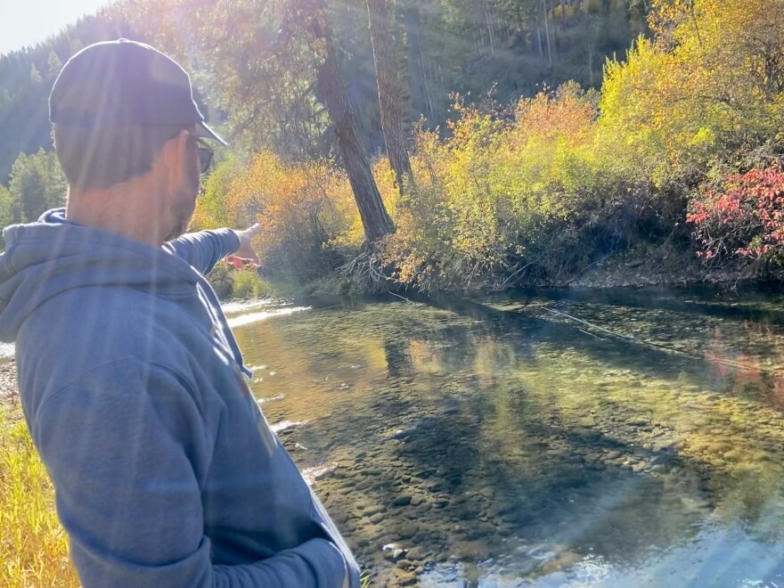Casey Baldwin, a research scientist with the Confederated Tribes of the Colville Reservation, points out a salmon nest, or redd, on the Sanpoil River.