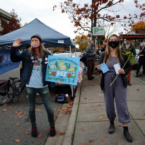 People First Bellingham campaign volunteers Seth Mangold and Sage Jones sought voter support for their coalition's four initiatives at the Bellingham Farmers Market on Saturday.