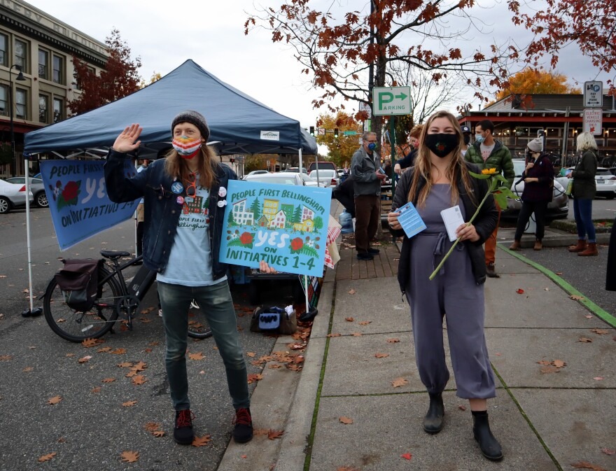 People First Bellingham campaign volunteers Seth Mangold and Sage Jones sought voter support for their coalition's four initiatives at the Bellingham Farmers Market on Saturday.