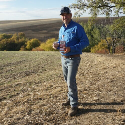 Nathan Rea holds a bottle of the first Salmon-Safe American single malt whiskey. Rea grew the barley used to make the whiskey in Walla Walla.