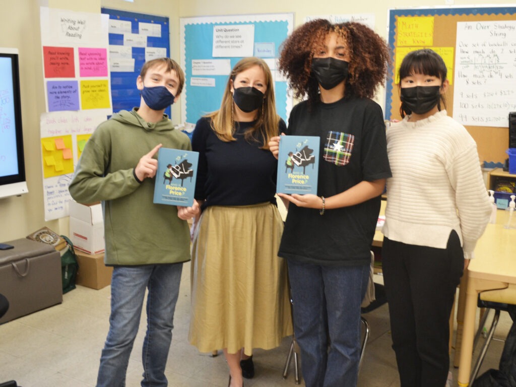 Three of the student authors of Who Is Florence Price? (left to right: Sebastián Núñez, Hazel Peebles and Sophia Shao), joined by their English teacher, Shannon Potts.