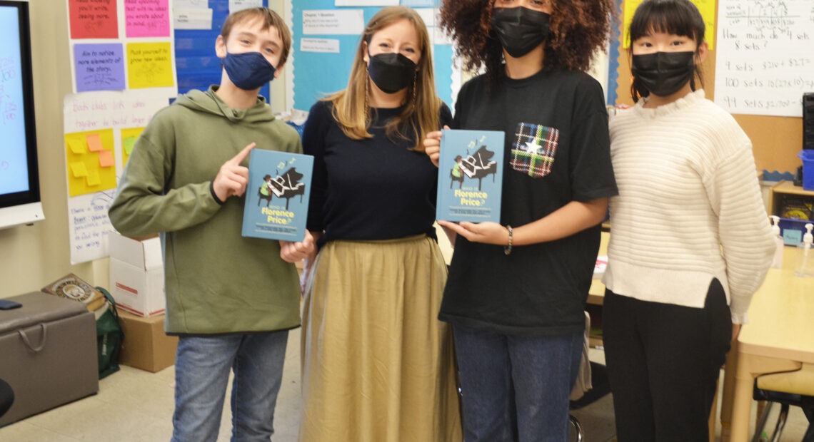 Three of the student authors of Who Is Florence Price? (left to right: Sebastián Núñez, Hazel Peebles and Sophia Shao), joined by their English teacher, Shannon Potts.