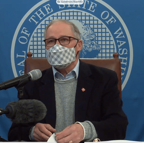 Washington Gov. Jay Inlsee with a mask on at a press conference