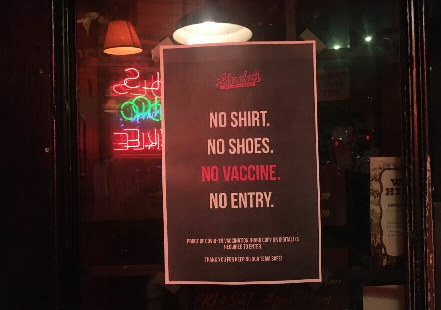 A sign outside Linda's Tavern in Seattle in late July 2021 asks customers for proof of vaccination against COVID-19.