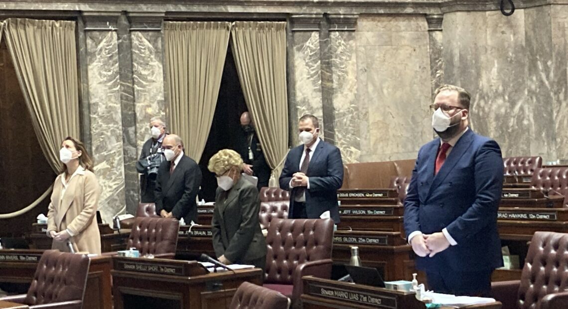 A limited group of masked state senators participated in person on the opening day of Washington's 2021 legislative session. Other senators joined remotely. The 2022 legislative session may look similar in light of rising COVID-19 cases.