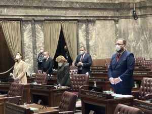A limited group of masked state senators participated in person on the opening day of Washington's 2021 legislative session. Other senators joined remotely. The 2022 legislative session may look similar in light of rising COVID-19 cases.