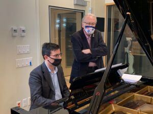 Composer Greg Yasinitsky (right) coaches pianist Fabio Menchetti (left) through the new music. 