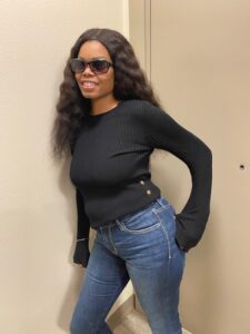 Black woman in black shirt and jeans