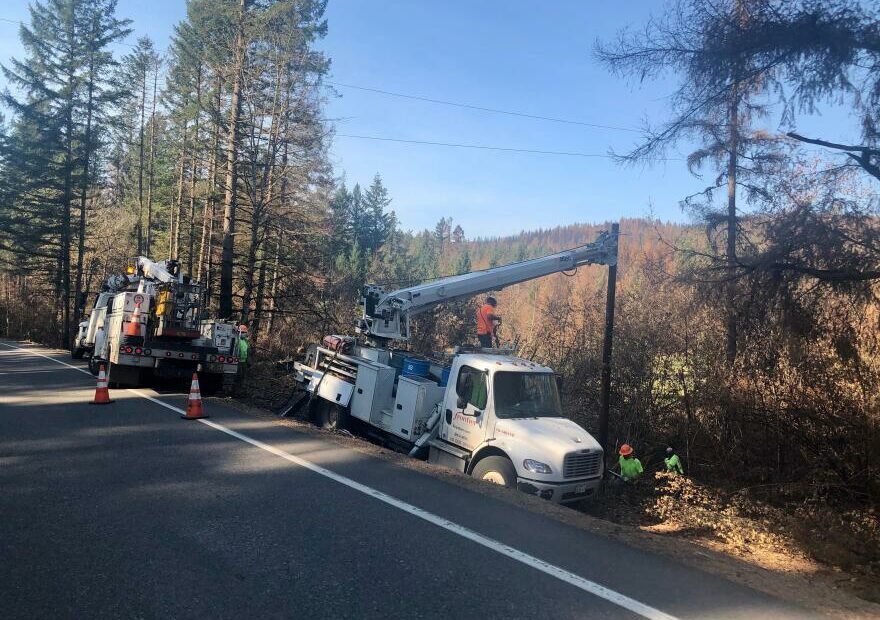 Utility crews replace power poles burned in the Beachie Creek Fire east of Salem in September 2020.