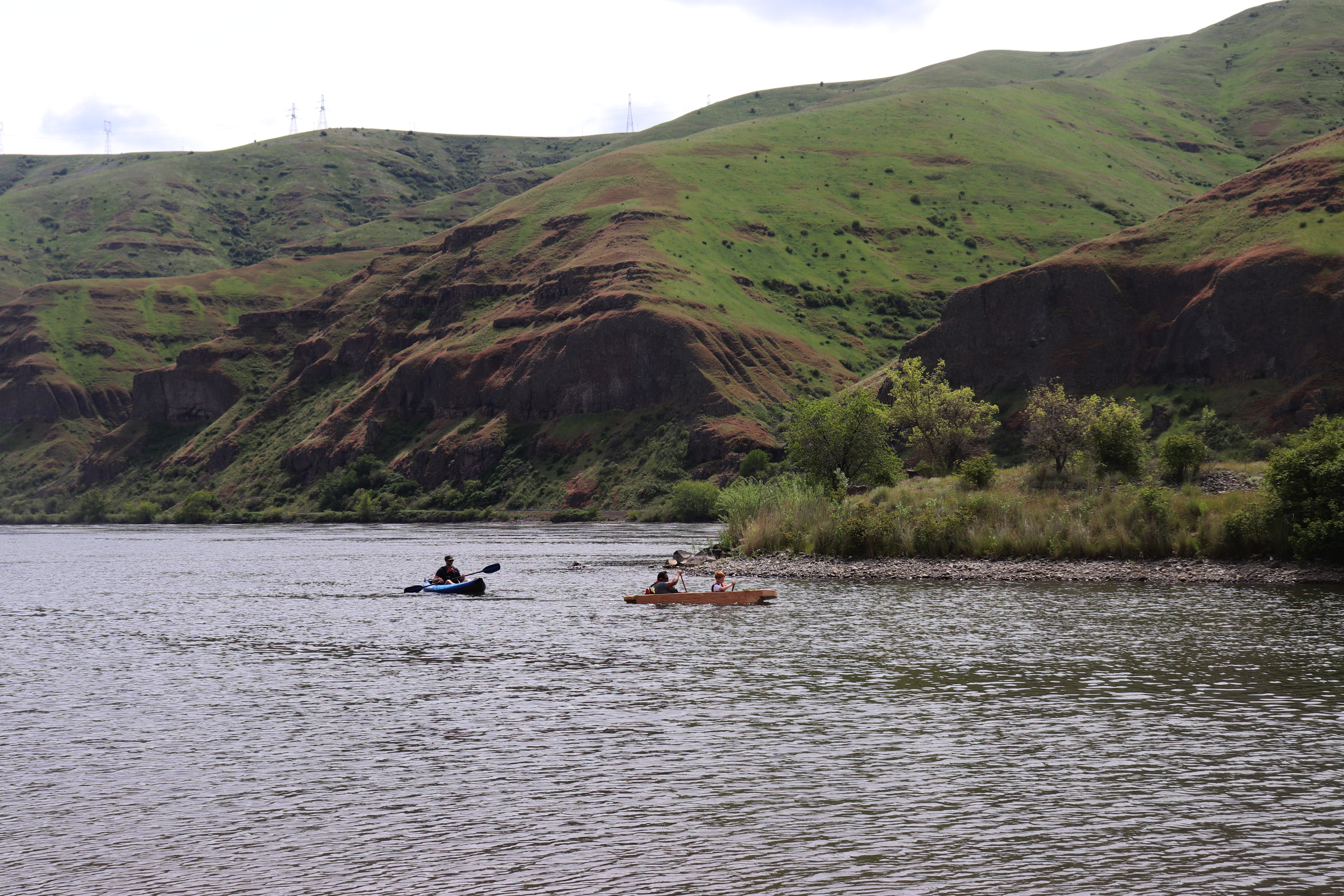Fourth-grader Russe;; Scott and Gary Dorr row across the water in a dugout canoe