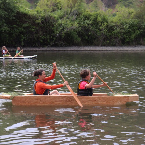 Lauren Venzke and Renée Hill row across the water in a dugout canoe