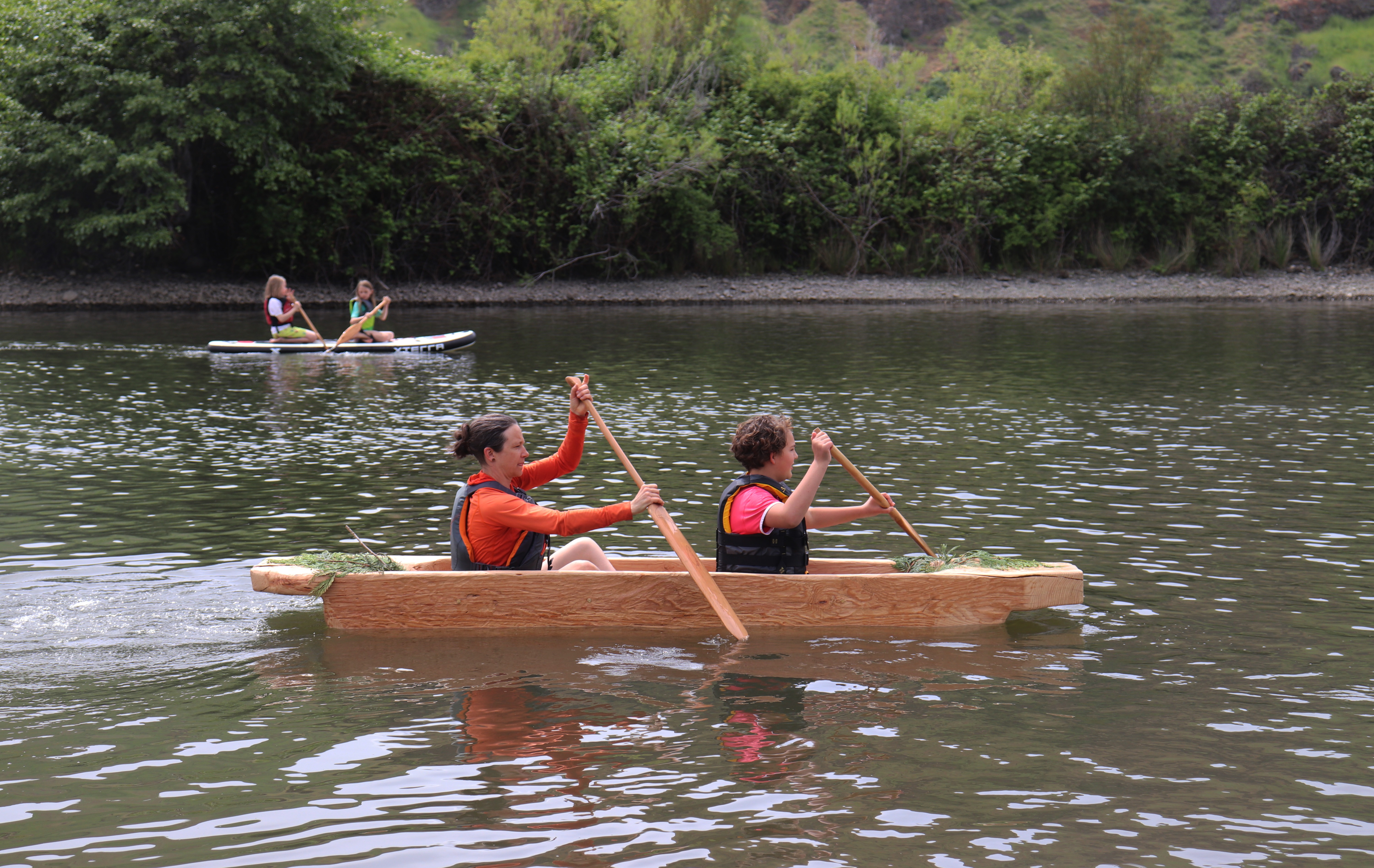 Lauren Venzke and Renée Hill row across the water in a dugout canoe