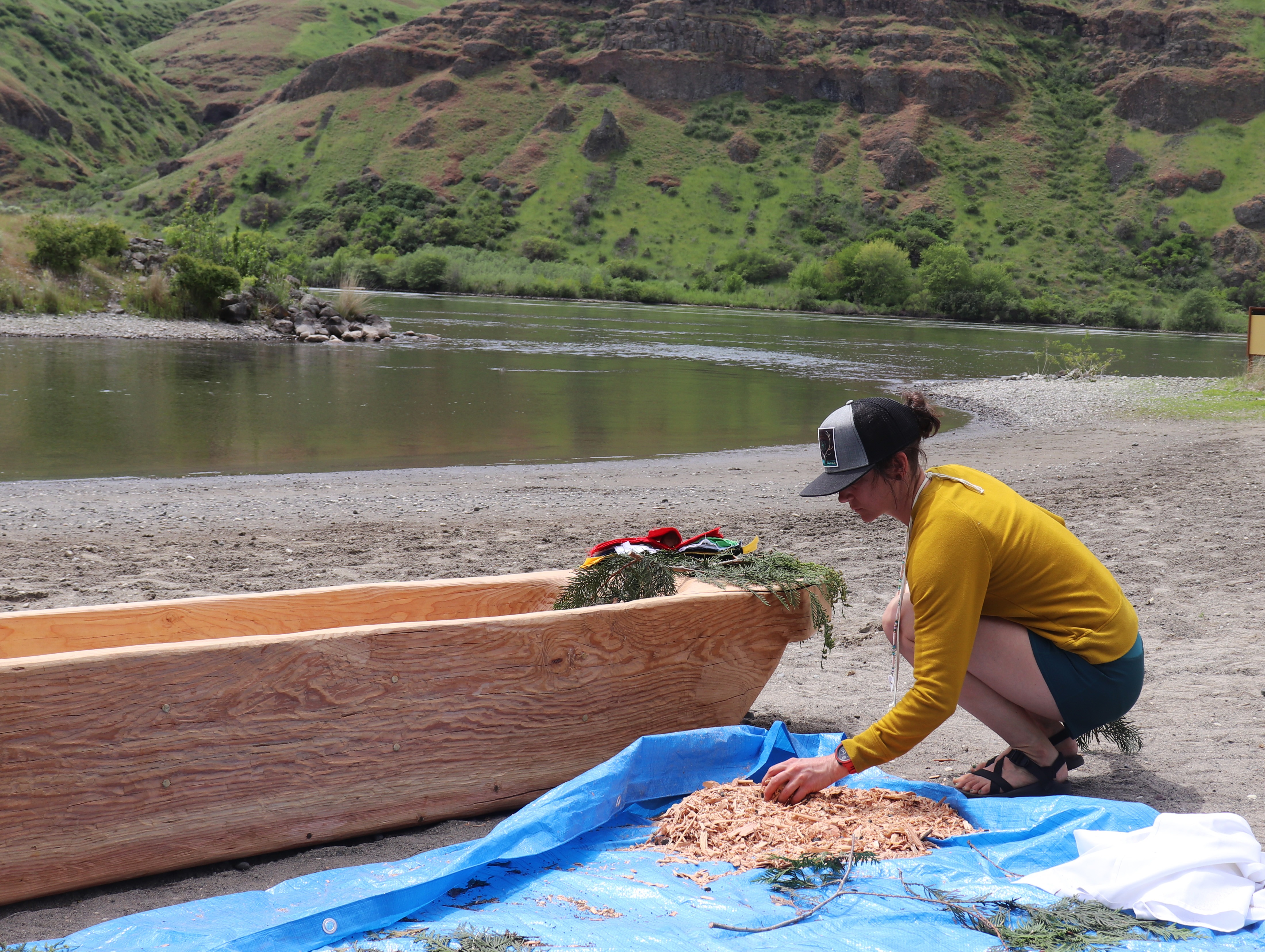 Renée Hill, 44, assembles wood shavings from the dugout canoe that will be used in the prayer ties