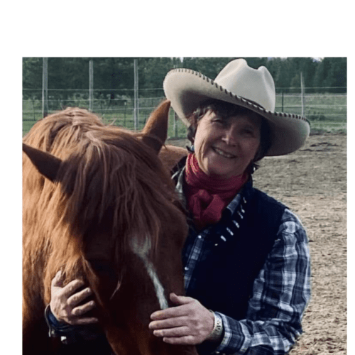 Woman holding nose of a happy horse.