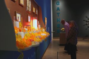 Museum goers admire "Ofrenda" by David Rios, one of the pieces in the GATHER: 27 Years of Hilltop Artists exhibit at the Tacoma Art Museum. Photo by Peter Berkley.