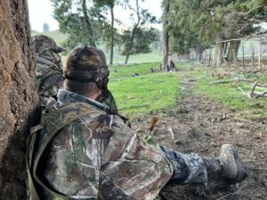 Keely Hopkins (left) listens as her mentor Aaron Garcia uses his turkey call while they hunt.