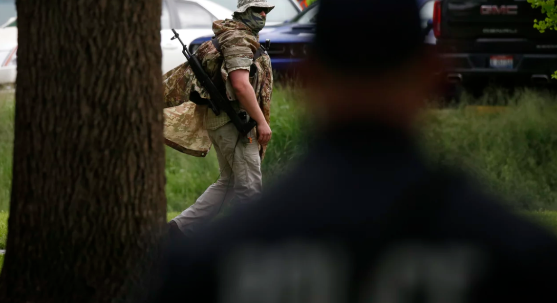 Man in fatigues with a rifle