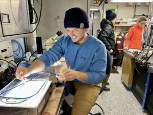 Scientist Kris Bauer gets a closer look at the Calanus marshallae copepods a bongo net pulled up off the coast of Grays Harbor, Washington.