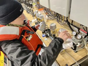 Talia Davis filters water to collect environmental-DNA, just a portion of the research happening aboard the Bell M. Shimada.