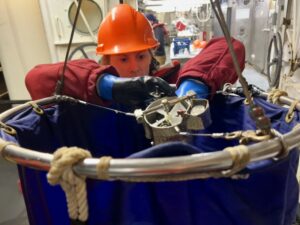 Scientist Laura Lilly gets a net ready to collect samples from the Pacific Ocean.