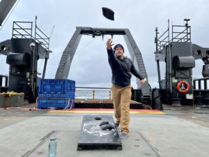 Scientist Kris Bauer tosses a bean bag during a game of cornhole.