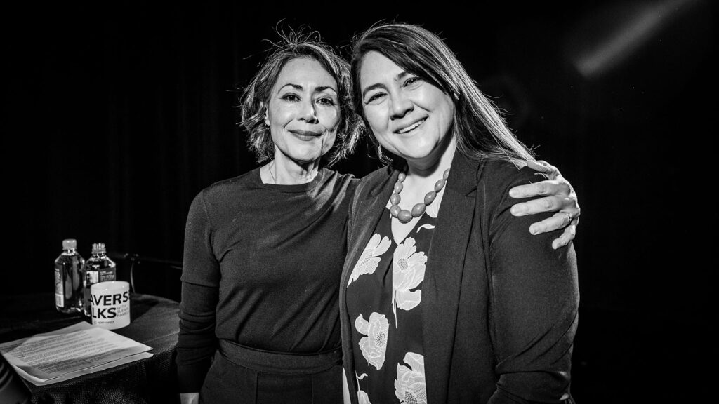 Ann, left, stands with her arm around Sueann, right, as they smile for the camera.