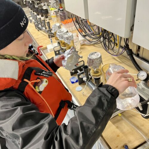 Talia Davis filters water to collect environmental-DNA, just a portion of the research happening aboard the Bell M. Shimada