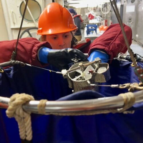 Scientist Laura Lilly gets a net ready to collect samples from the Pacific Ocean