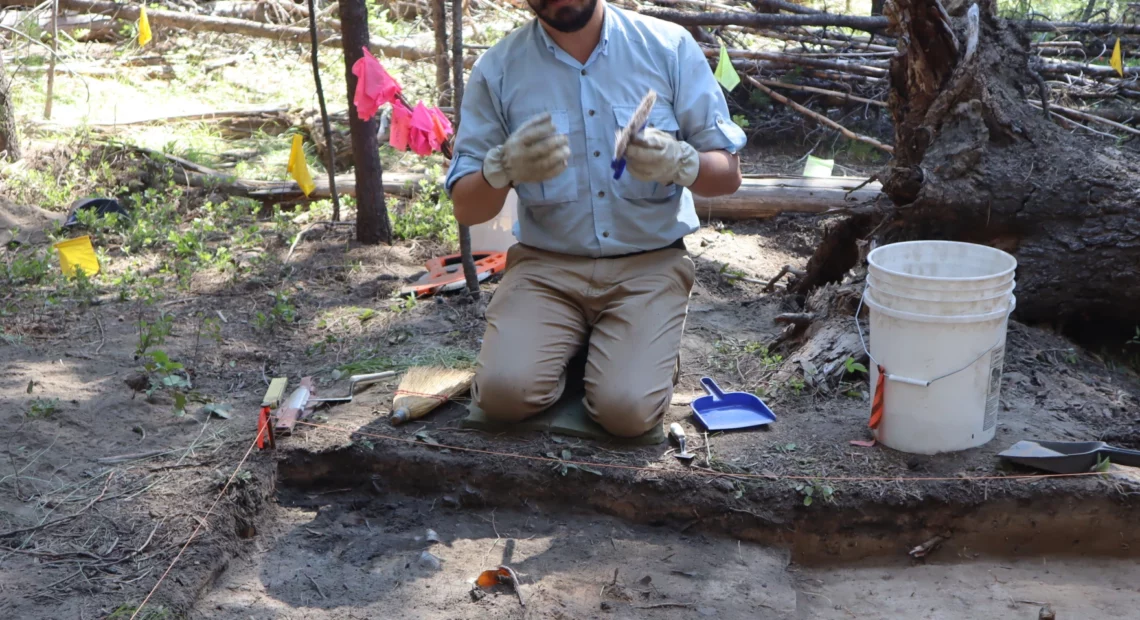 Southern Oregon University's Keoni Diacamos at work on July 21 excavating the site of a home in the vanished company town that once surrounded the Baker White Pine Mill.