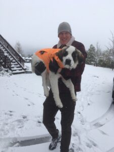 In this photo, listener Stephen Barbuto holds a dog in front of a snowy background.