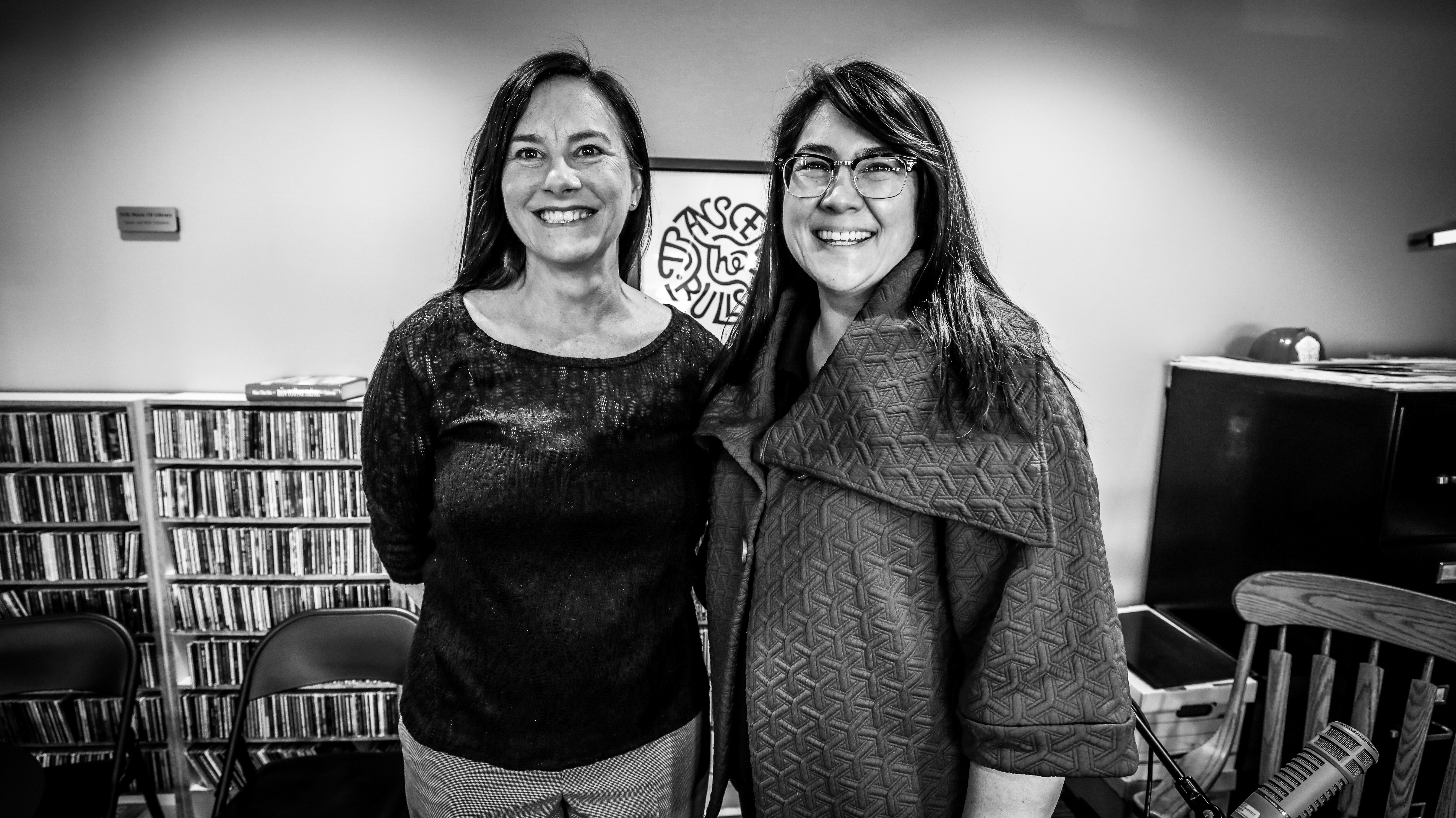 Sarah Zabel stands on the left of Sueann Ramella. They both smile for the camera.