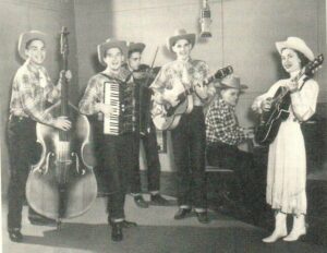 Photo of six people on various instruments.