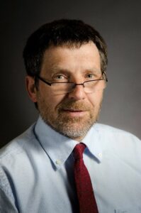 White man in white business shirt with red tie