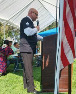 white man speaking at podium