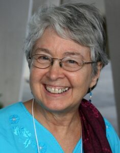 silver haired woman in glasses