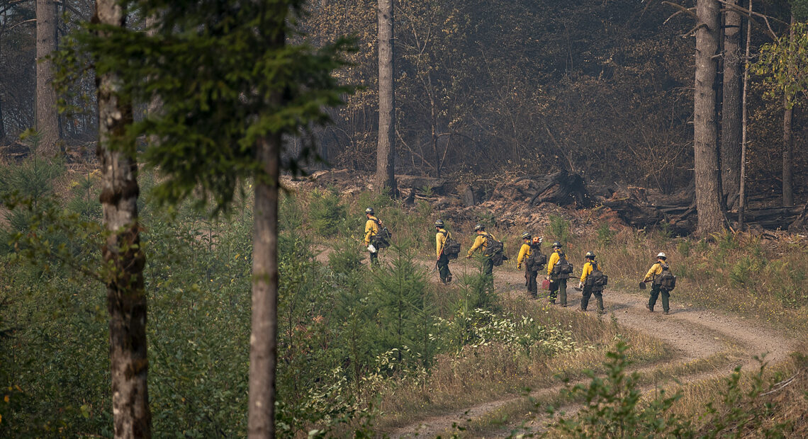 Fire crews navigate terrain while working at the Nakia Fire on Wednesday afternoon, Oct. 19, 2022. (Amanda Cowan/The Columbian)