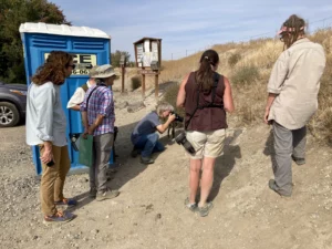 Members of the Washington Butterfly Association watch Western pygmy blue butterflies near a porta potty. Entomologist David James (center) took 14 butterfly enthusiasts on a tour of an area near Richland, Washington, that guaranteed sightings of the butterflies.