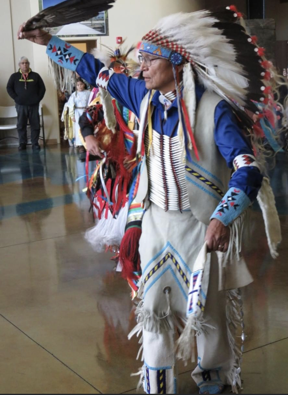 Native American man wearing traditional clothing used in a dance.