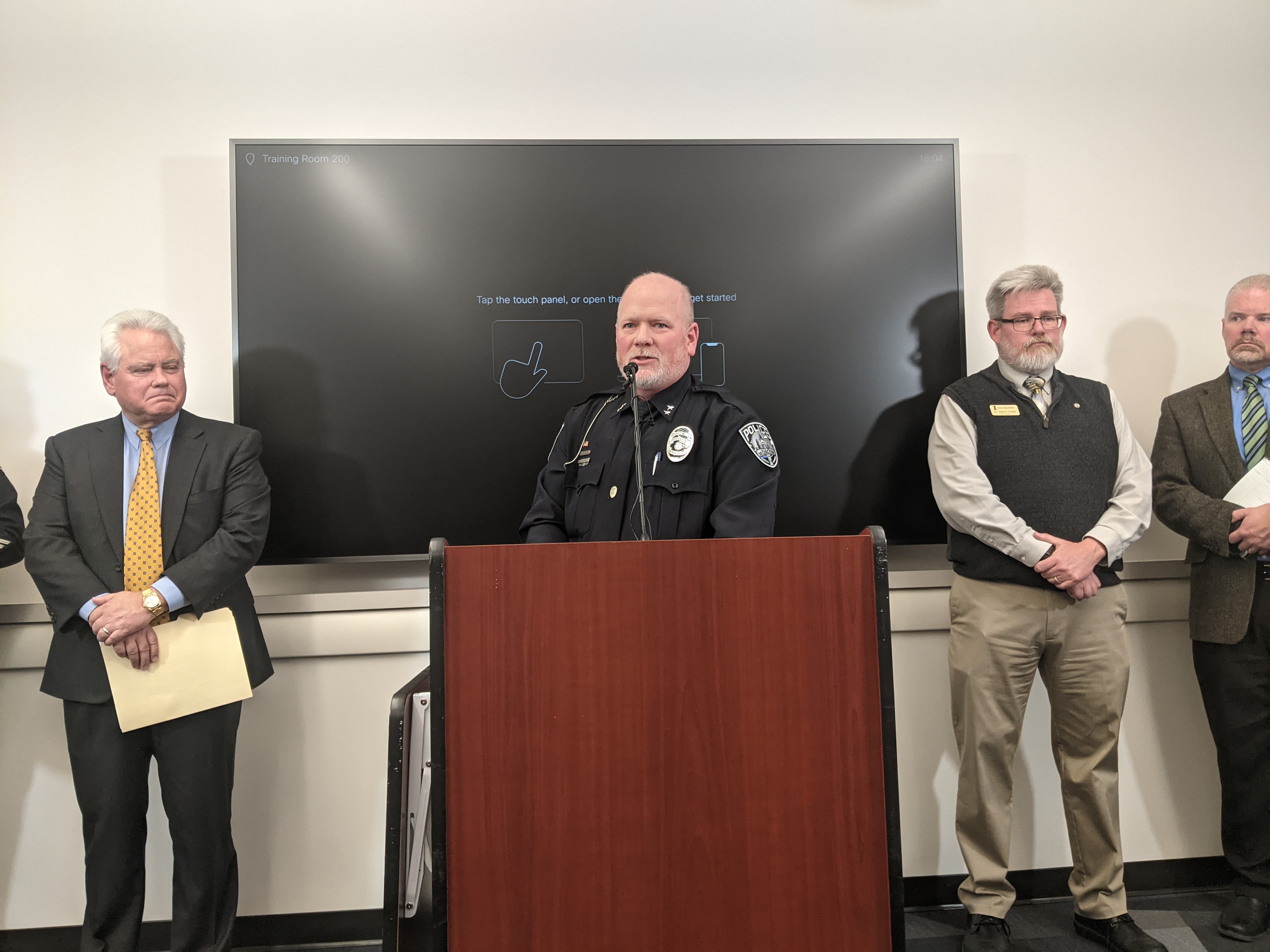 Police stand at a podium