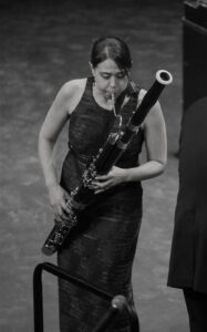 Dr. Jacqueline Wilson of Yakama plays the Bassoon in a long dress.