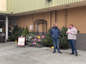 Mark McLaughlin, right, talks to another member as they pass out leaflets about the wage problem on December 16. Photo by Lauren Gallup.