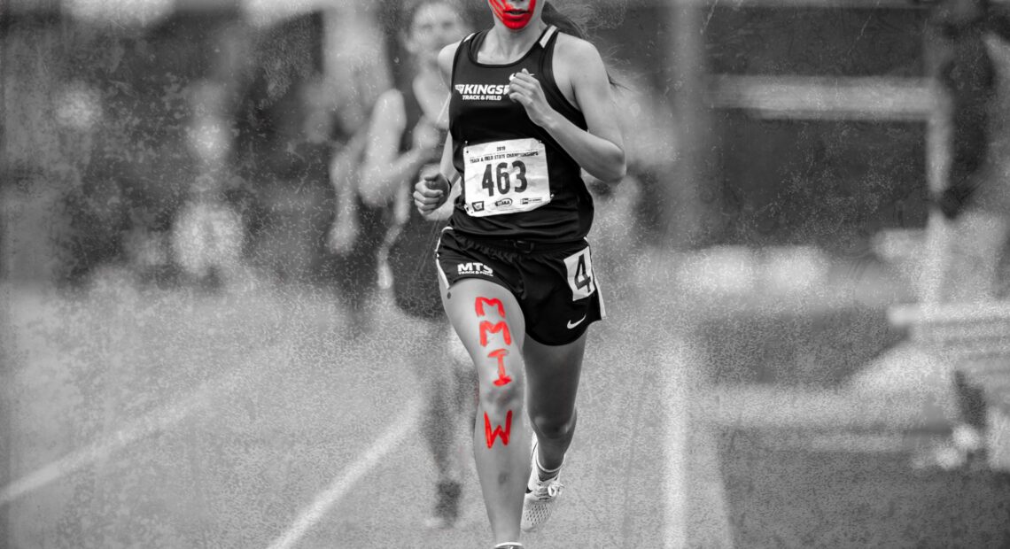 Rosalie Fish, running with a painted red handprint across her face and the letters "MMIW" along her leg to raise awareness of the Missing and Murdered Indigenous Women crisis. Photo courtesy of Fish.