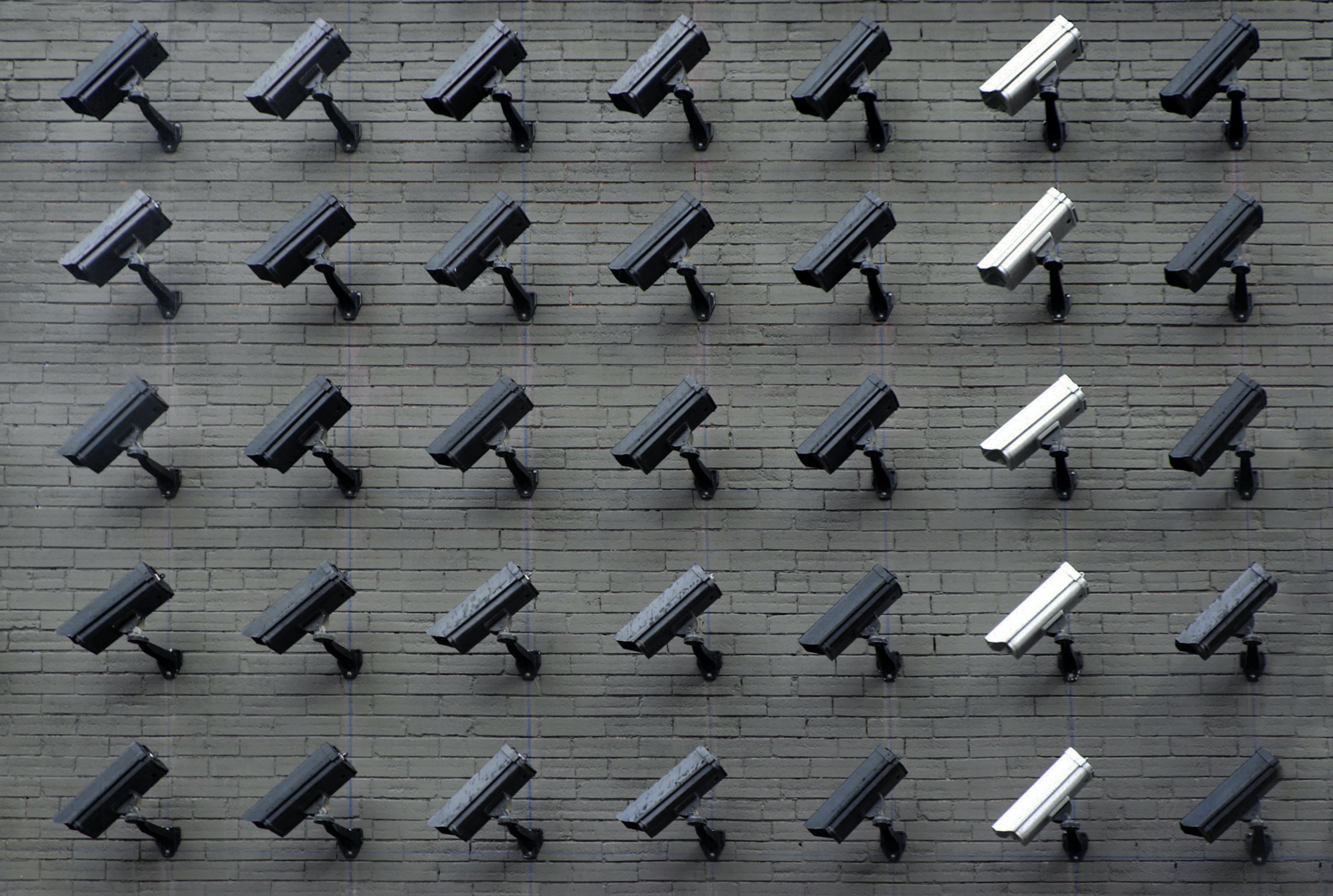 Varying security cameras lined up. A growing number of privacy concerns are being raised about automated tracking and data sharing and storing, locally and nationwide. Photo by Lianhao Qu via Unsplash.