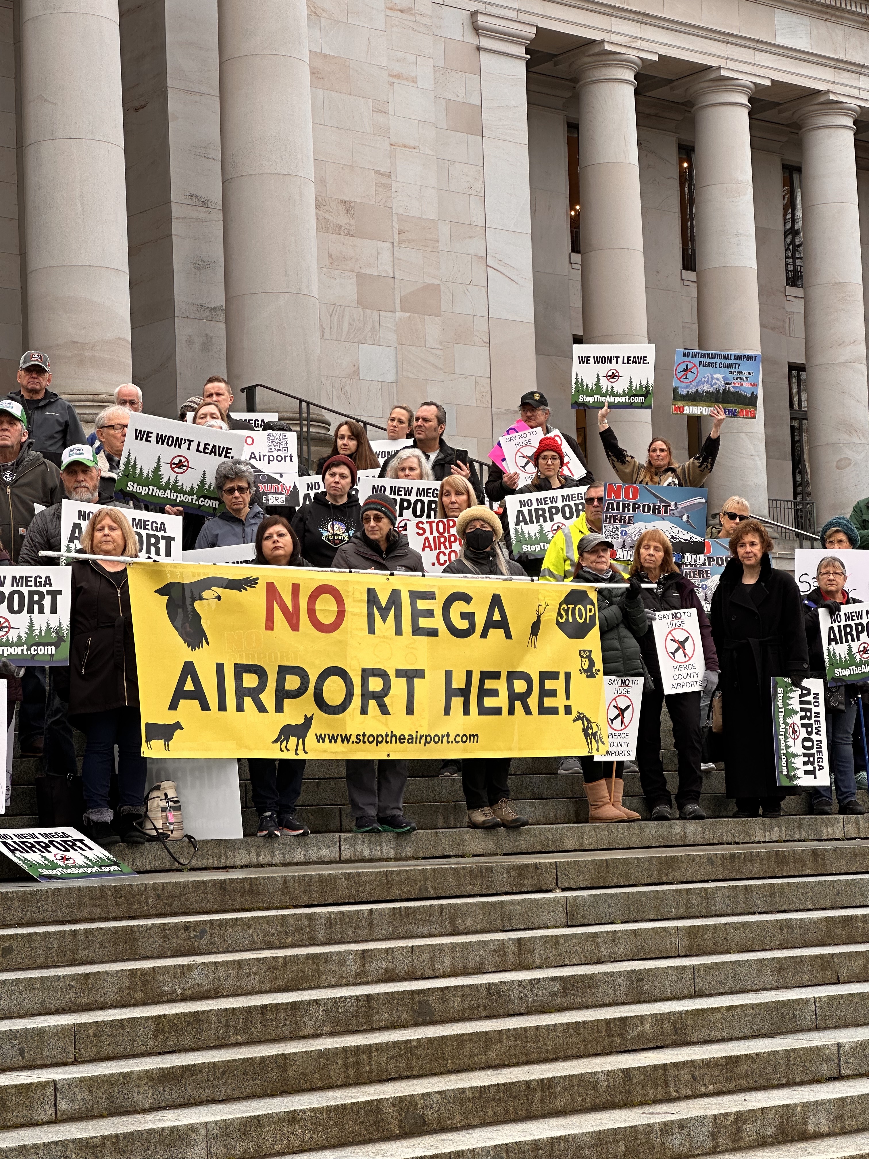 Protestors hold a sign that reads "No Mega Airport Here," at the state capitol on January 25. Photo by Lauren Gallup.