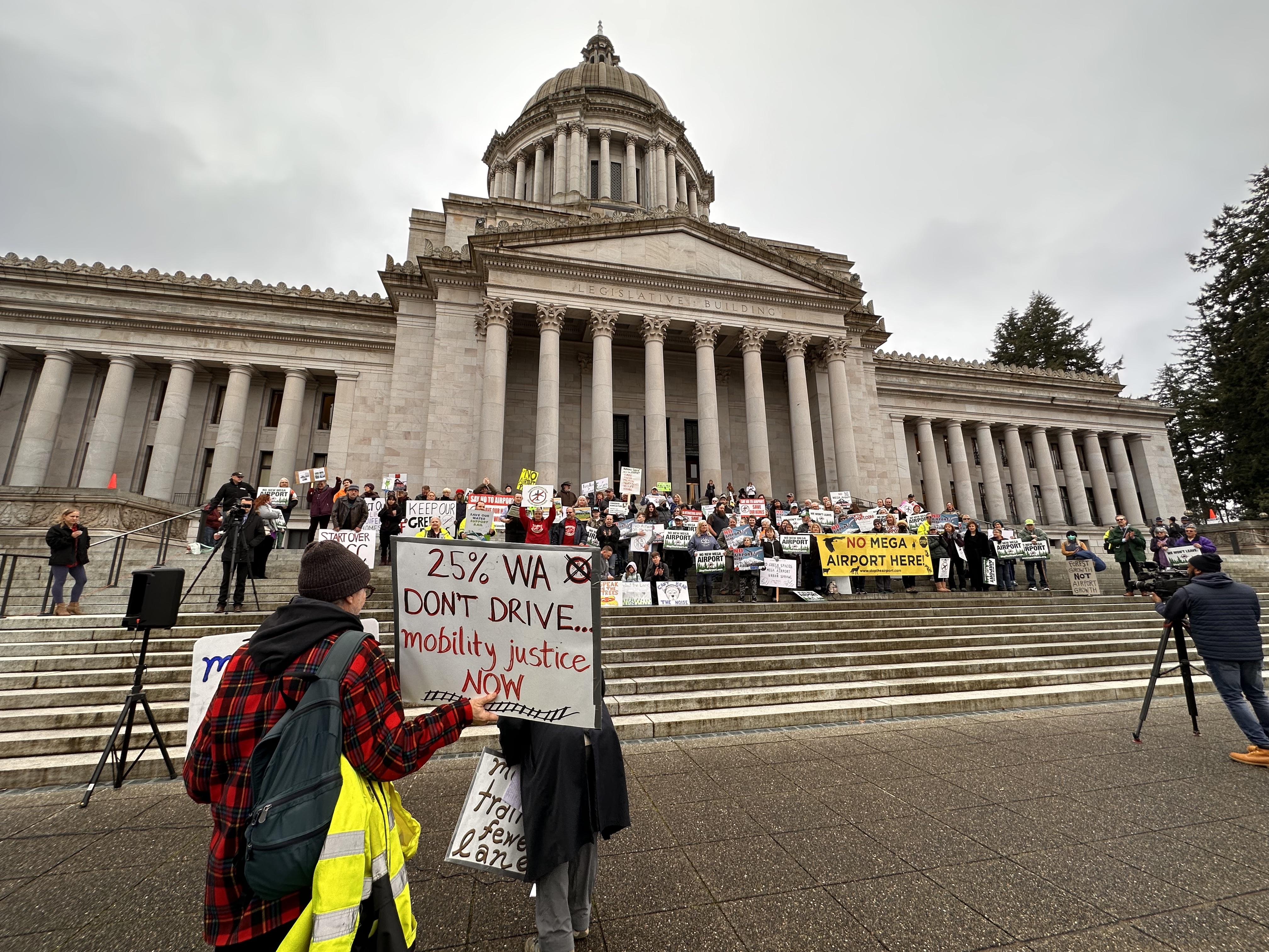 A crowd gathered on the north steps of the Capitol building on Wednesday, January 25, to protest three proposed greenfield sites for a new airport in Pierce or Thurston County. Photo by Lauren Gallup.