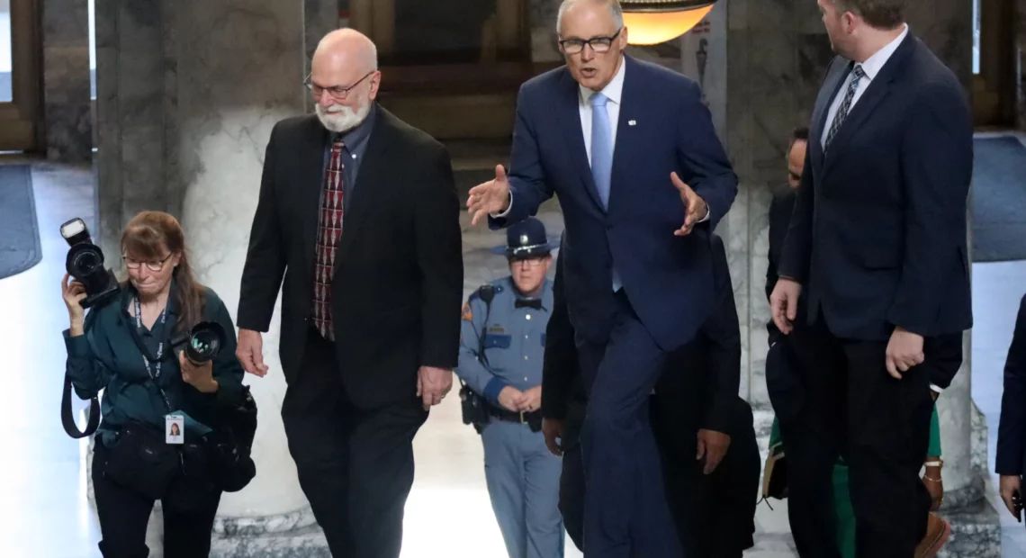 Washington Gov. Jay Inslee walks through the Capitol building in Olympia, en route to deliver his annual State of the State address, Jan. 10, 2023